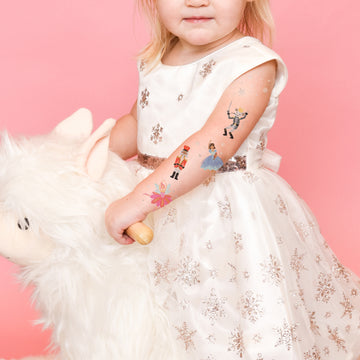 Shine bright in the Nutcracker Variety Set from Flash Tattoos featuring 25 assorted holiday inspired kids temporary tattoos: Clara, Nutcracker, Sugar Plum Fairy, Rat King and Snow shimmer.